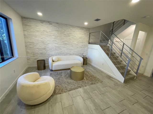 764 NE 206th Ter, Miami, FL 33179 - living area featuring wood tiled floor, visible vents, baseboards, and stairway