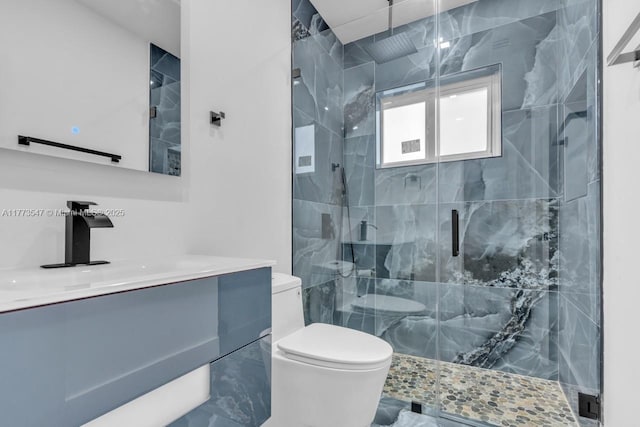bathroom featuring vanity, a stall shower, and toilet