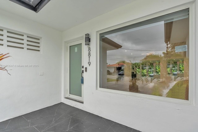 entrance to property with stucco siding