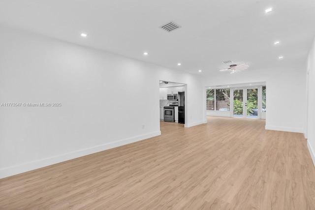 unfurnished living room with recessed lighting, baseboards, visible vents, and light wood-style floors