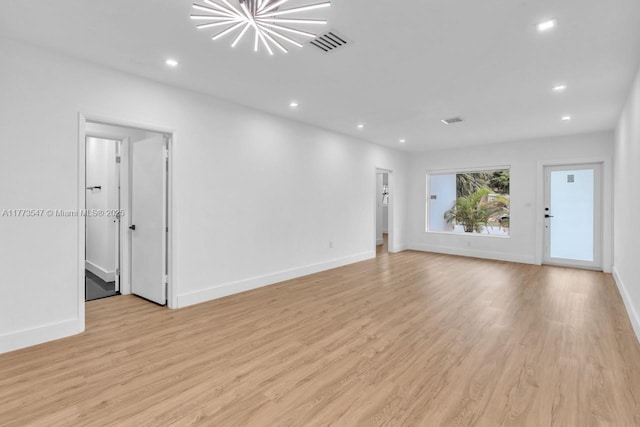 unfurnished living room with visible vents, recessed lighting, light wood-style flooring, and baseboards