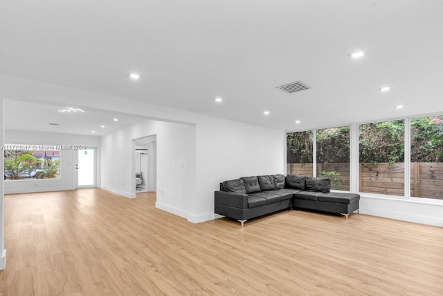 living area featuring recessed lighting, baseboards, visible vents, and light wood finished floors