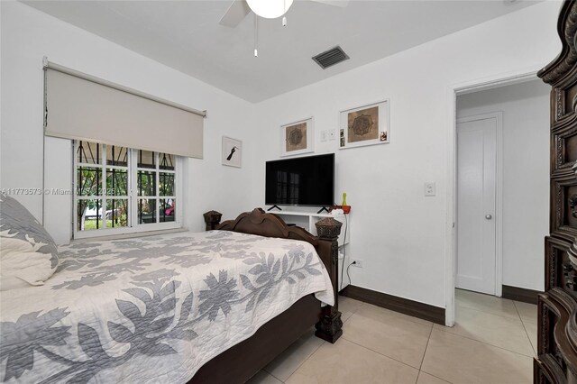 bedroom with light tile patterned flooring, baseboards, ceiling fan, and visible vents