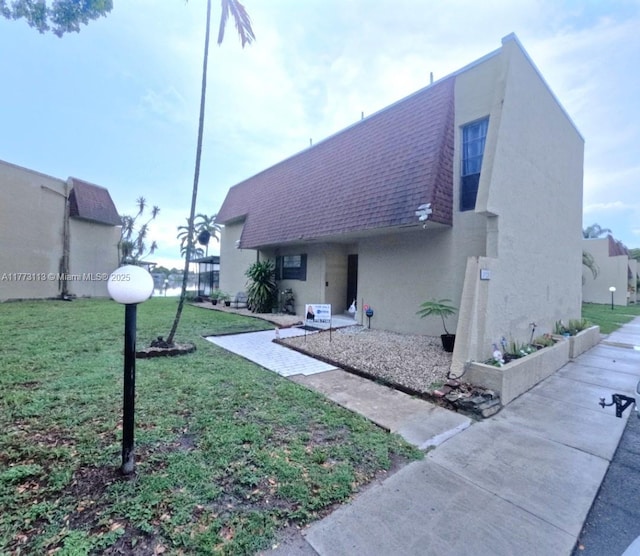 8920 Palm Tree Ln Unit 8920, Pembroke Pines, FL 33024 - view of front of home with a shingled roof, stucco siding, and a front yard