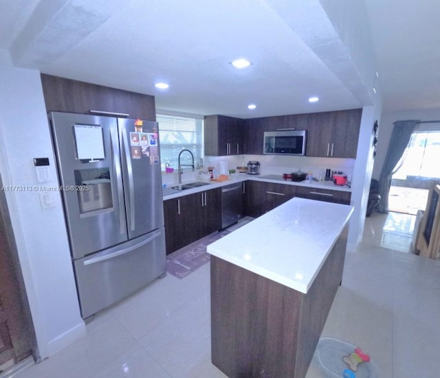 8920 Palm Tree Ln Unit 8920, Pembroke Pines, FL 33024 - kitchen with appliances with stainless steel finishes, modern cabinets, dark brown cabinetry, a kitchen island, and recessed lighting