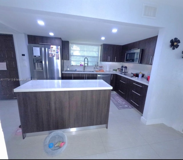 8920 Palm Tree Ln Unit 8920, Pembroke Pines, FL 33024 - kitchen featuring stainless steel appliances, a kitchen island, light countertops, dark brown cabinetry, and recessed lighting