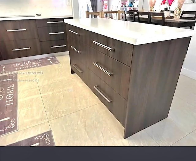 8920 Palm Tree Ln Unit 8920, Pembroke Pines, FL 33024 - detailed view of modern cabinets, dark brown cabinets, light countertops, and a center island