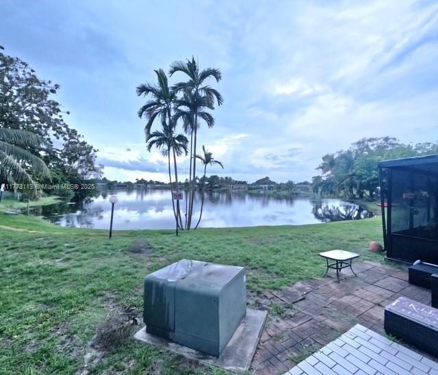 8920 Palm Tree Ln Unit 8920, Pembroke Pines, FL 33024 - view of grassy yard featuring a water view and a patio area