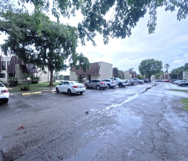 8920 Palm Tree Ln Unit 8920, Pembroke Pines, FL 33024 - uncovered parking lot featuring a residential view