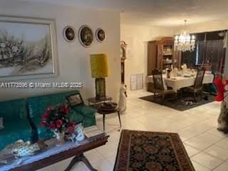1010 NW 57th St, Miami, FL 33127 - tiled living room featuring a chandelier