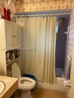 1010 NW 57th St, Miami, FL 33127 - full bathroom featuring wallpapered walls, toilet, shower / bath combo, and vanity
