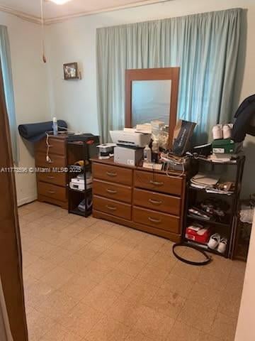 1010 NW 57th St, Miami, FL 33127 - bedroom featuring crown molding, an office area, and light floors