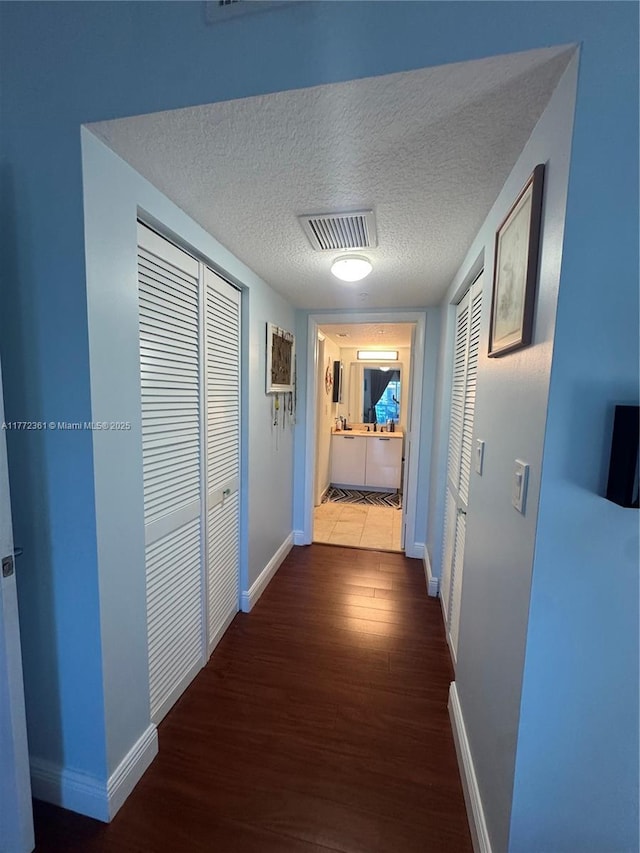 1800 N Bayshore Dr Unit 1404, Miami, FL 33132 - hallway with wood finished floors, baseboards, and a textured ceiling