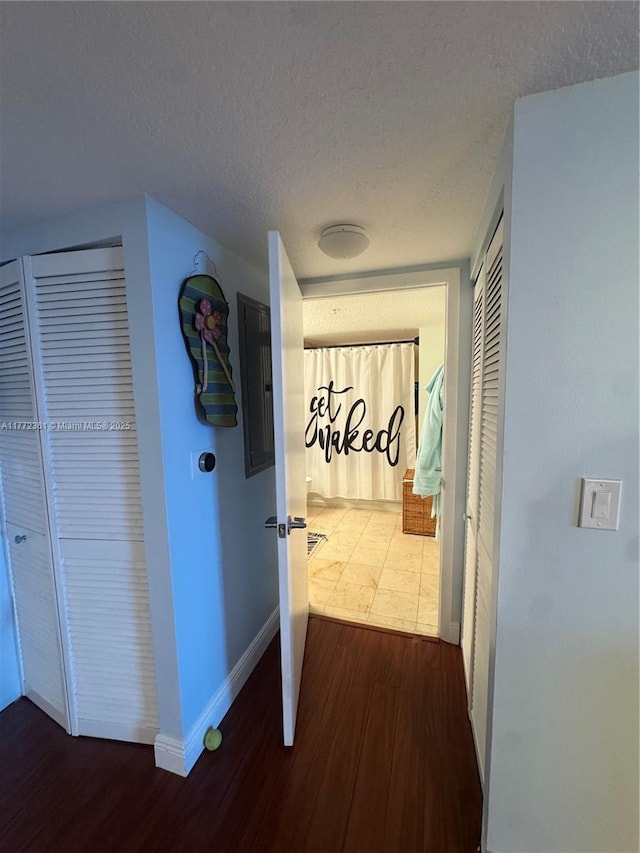 1800 N Bayshore Dr Unit 1404, Miami, FL 33132 - corridor with wood finished floors, baseboards, a textured ceiling, and electric panel