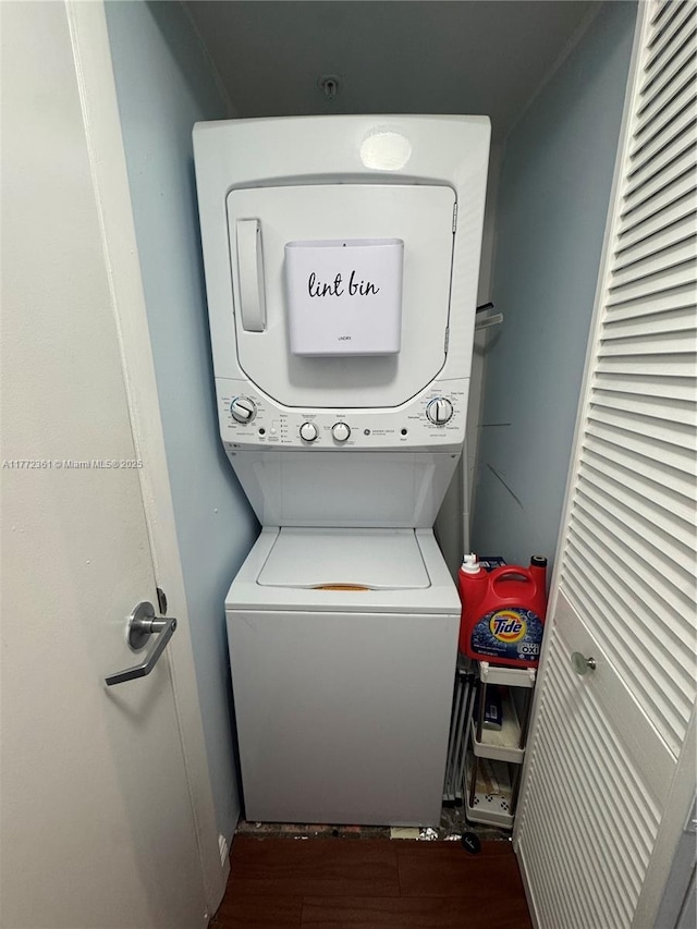 1800 N Bayshore Dr Unit 1404, Miami, FL 33132 - washroom featuring stacked washing machine and dryer and wood finished floors