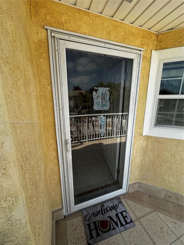 entrance to property with stucco siding