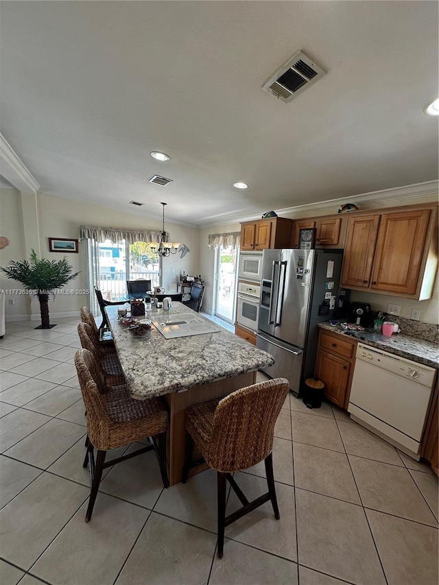 dining room with an inviting chandelier, light tile patterned floors, ornamental molding, and visible vents