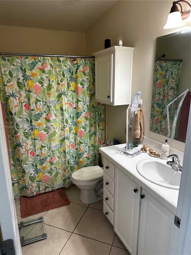 full bath with a shower with shower curtain, toilet, tile patterned flooring, and vanity