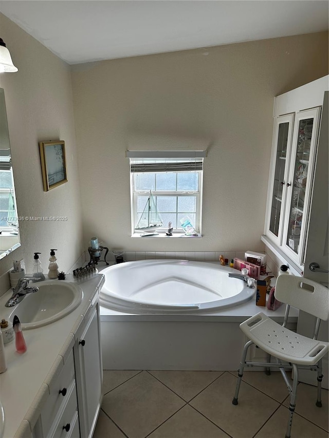 full bathroom featuring a bath, tile patterned flooring, and vanity
