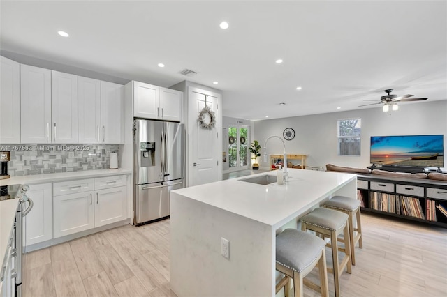 709 SW 17th St, Fort Lauderdale, FL 33315 - kitchen with a breakfast bar, a healthy amount of sunlight, stainless steel appliances, and a sink