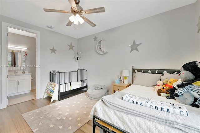 709 SW 17th St, Fort Lauderdale, FL 33315 - bedroom with a sink, wood finished floors, visible vents, a ceiling fan, and connected bathroom