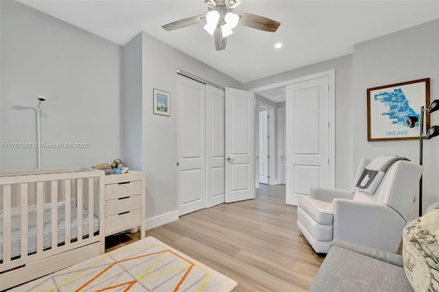 709 SW 17th St, Fort Lauderdale, FL 33315 - bedroom featuring a closet, ceiling fan, a crib, baseboards, and light wood-style floors