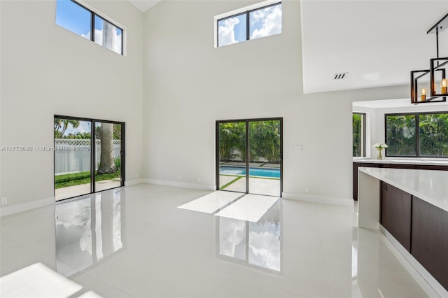 20160 NW 9th Dr, Pembroke Pines, FL 33029 - unfurnished living room featuring a high ceiling and light tile patterned floors