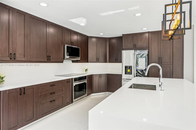 20160 NW 9th Dr, Pembroke Pines, FL 33029 - kitchen featuring stainless steel appliances, light countertops, hanging light fixtures, dark brown cabinetry, and recessed lighting