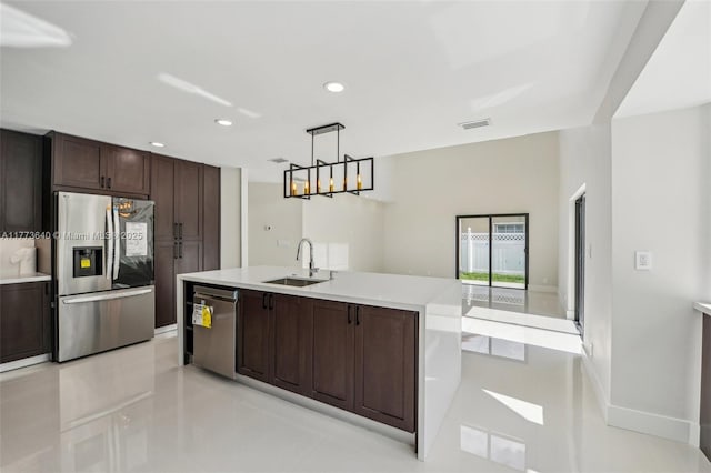 20160 NW 9th Dr, Pembroke Pines, FL 33029 - kitchen with appliances with stainless steel finishes, dark brown cabinets, light countertops, an island with sink, and recessed lighting