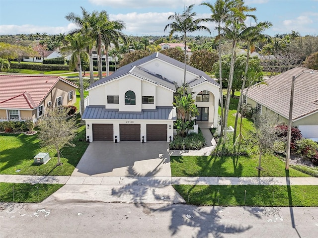 20160 NW 9th Dr, Pembroke Pines, FL 33029 - view of front of property featuring a garage, concrete driveway, stucco siding, a standing seam roof, and a front lawn