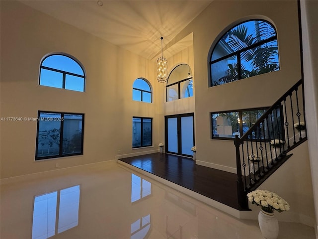 20160 NW 9th Dr, Pembroke Pines, FL 33029 - foyer entrance with plenty of natural light, a towering ceiling, a chandelier, stairway, and french doors