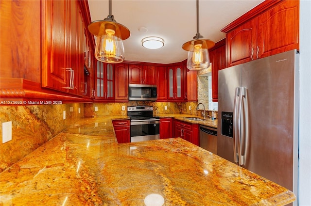 219 NE 11th Ave Unit 2, Hallandale Beach, FL 33009 - kitchen featuring tasteful backsplash, a sink, dark brown cabinets, appliances with stainless steel finishes, and glass insert cabinets