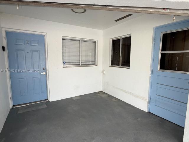 doorway to property with stucco siding