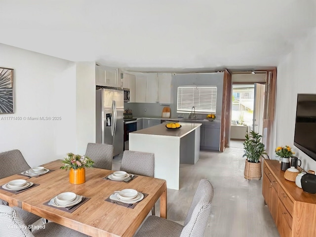 dining space featuring light wood-type flooring