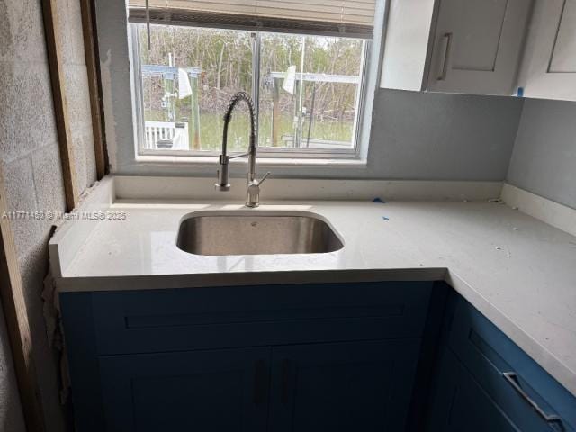 kitchen featuring light countertops and a sink