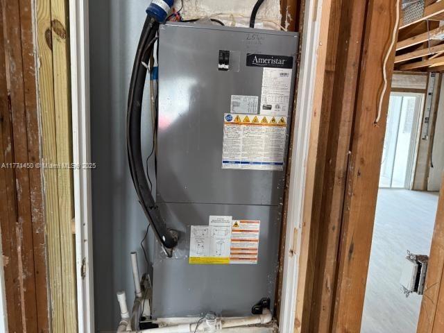 utility room featuring heating unit