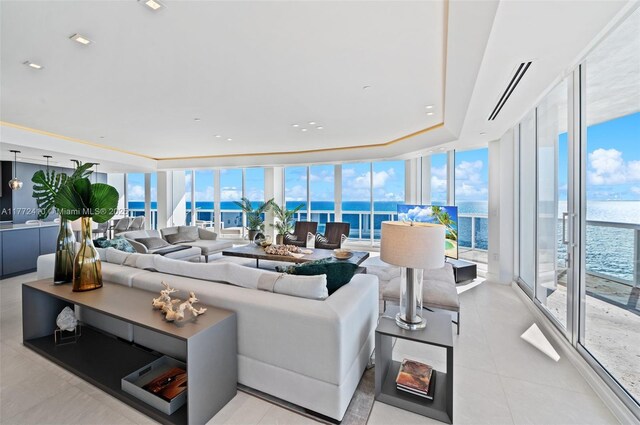 9601 Collins Ave Unit 1506, Bal Harbour, FL 33154 - living area featuring light tile patterned flooring, a wall of windows, a water view, and a tray ceiling