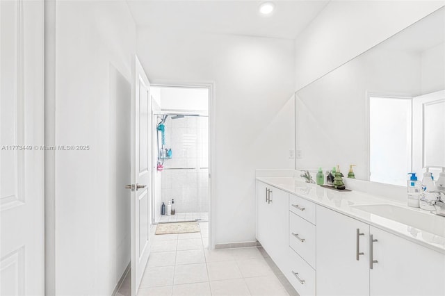 full bathroom with a sink, double vanity, tile patterned floors, baseboards, and a shower stall