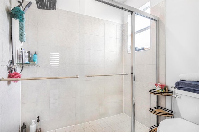 bathroom featuring a stall shower and toilet