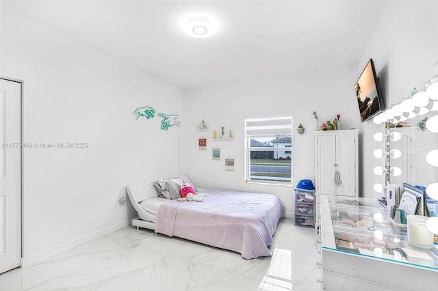 bedroom featuring marble finish floor