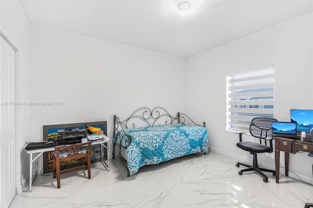 bedroom with baseboards and marble finish floor