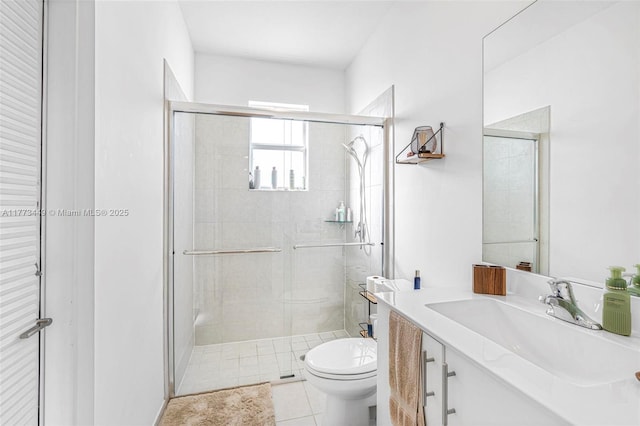 bathroom featuring vanity, tile patterned floors, toilet, and a shower stall