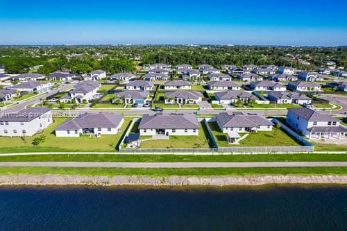 birds eye view of property with a water view and a residential view
