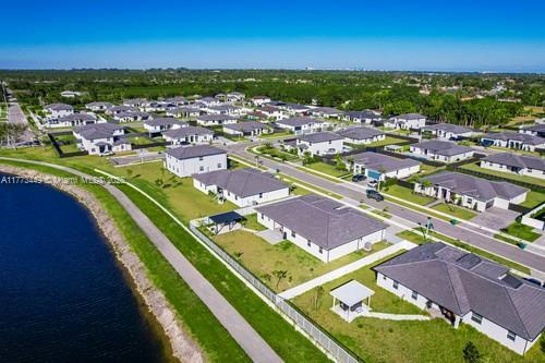 birds eye view of property with a residential view and a water view