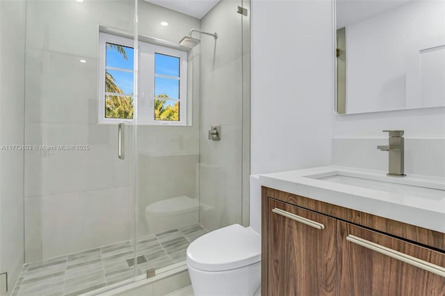 full bathroom featuring vanity, toilet, and a shower stall
