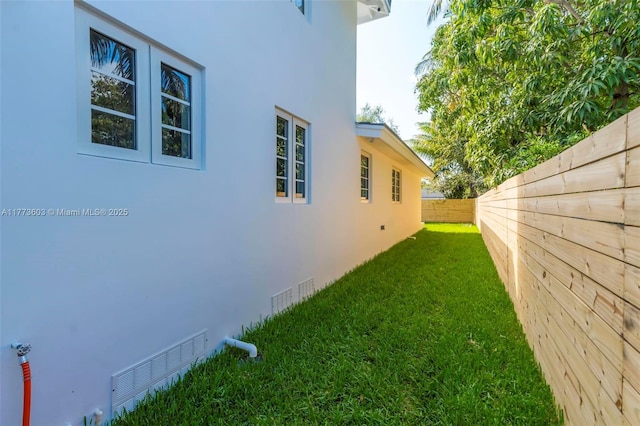 view of yard featuring a fenced backyard and visible vents