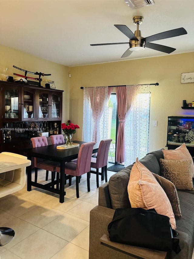 dining area with light tile patterned flooring, ceiling fan, and visible vents