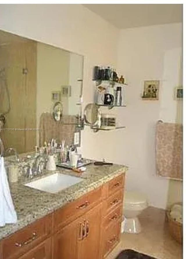 bathroom featuring toilet and vanity