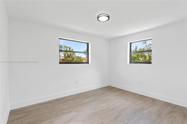601 NW 35th Ter, Lauderhill, FL 33311 - empty room featuring light wood-type flooring, plenty of natural light, and baseboards