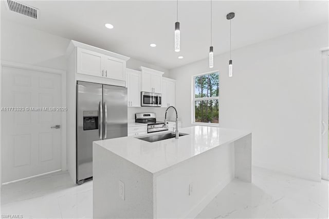 kitchen featuring marble finish floor, a sink, visible vents, white cabinets, and appliances with stainless steel finishes